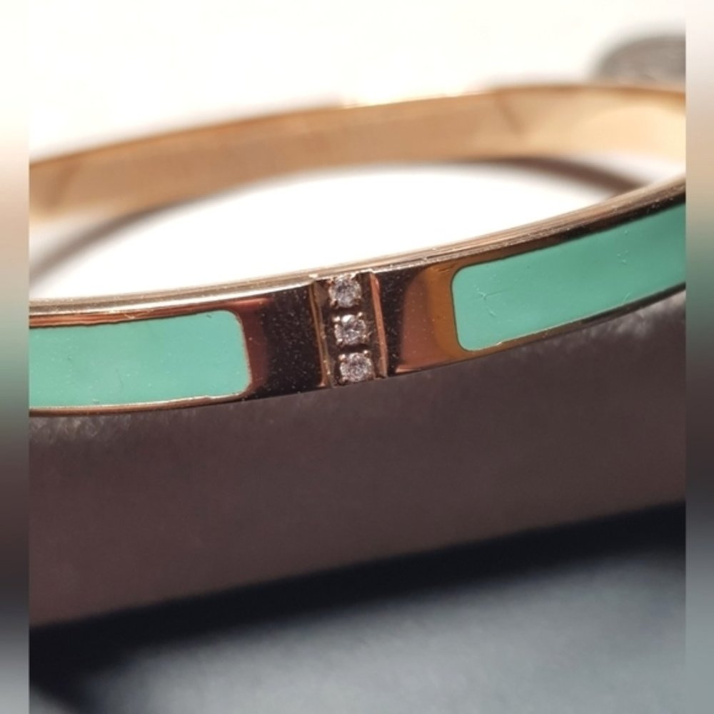 MIA gold tone and teal hinge bangle bracelet